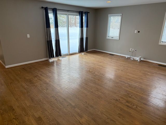 spare room with hardwood / wood-style floors