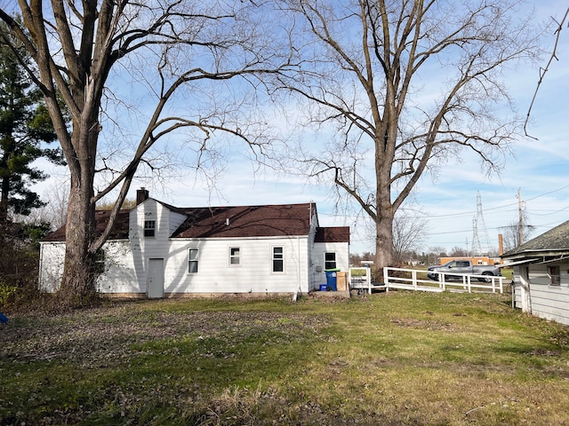 view of side of home with a yard