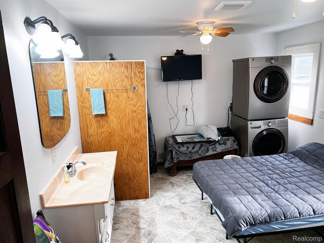 2360 Virginia Ave, Saginaw, MI 48601 - bathroom featuring stacked washer and clothes dryer, a ceiling fan, and vanity
