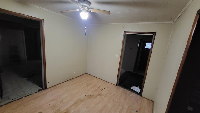 interior space with ceiling fan, light wood-type flooring, and crown molding