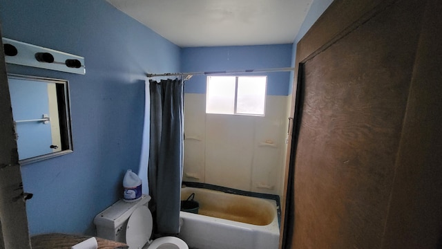 bathroom with toilet and bathing tub / shower combination