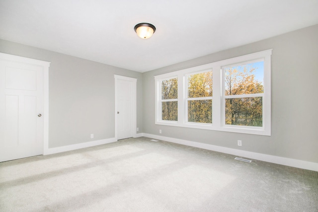 empty room featuring light carpet