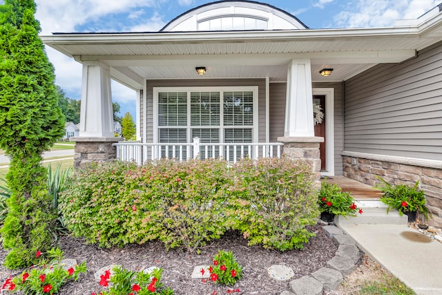 doorway to property featuring covered porch