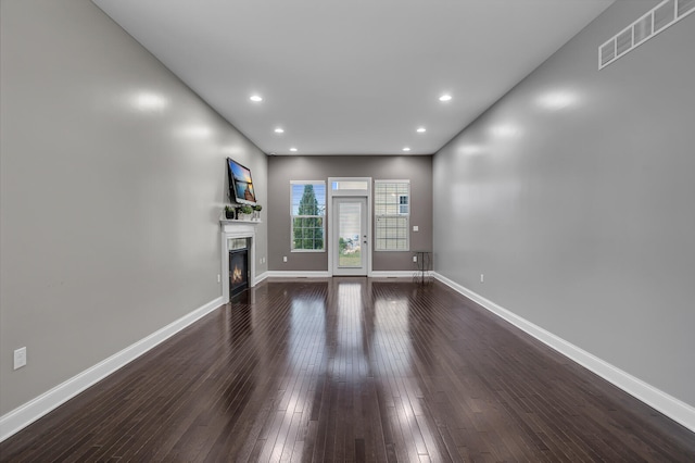 unfurnished living room with dark hardwood / wood-style flooring