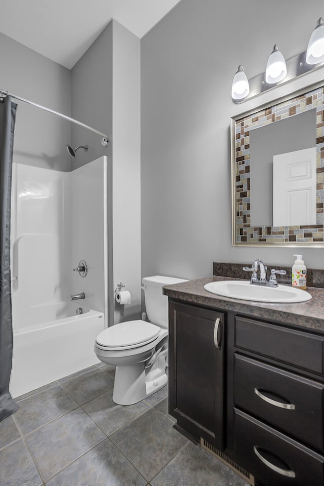 full bathroom featuring tile patterned floors, vanity, toilet, and shower / tub combo with curtain