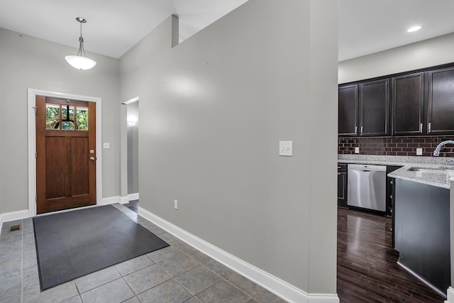 foyer featuring wood-type flooring and sink