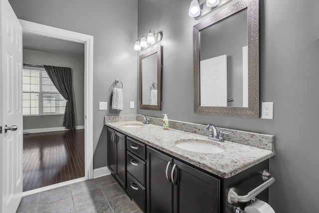 bathroom with hardwood / wood-style floors and vanity