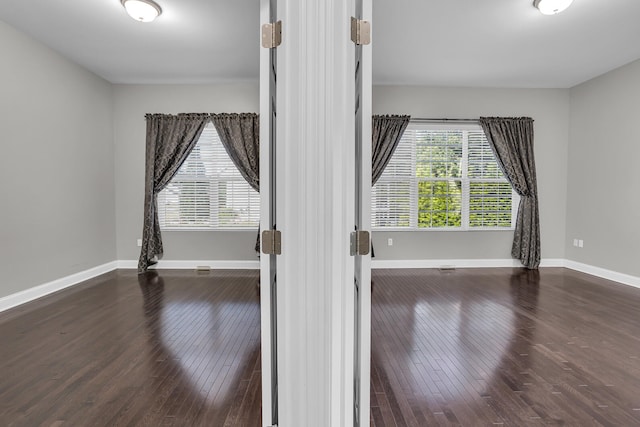 empty room with dark hardwood / wood-style floors