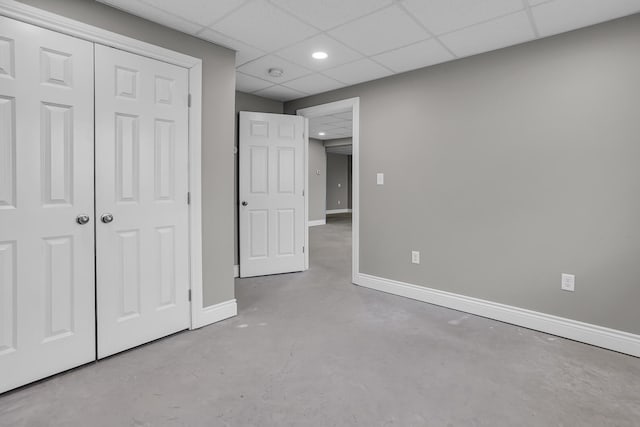 unfurnished bedroom with a paneled ceiling and a closet