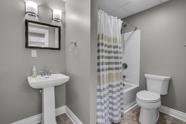 bathroom featuring tile patterned floors, shower / bath combo with shower curtain, and toilet