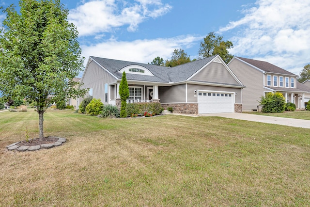 view of front facade featuring a porch, a garage, and a front lawn