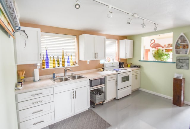 kitchen featuring stainless steel microwave, sink, white electric range, track lighting, and white cabinets
