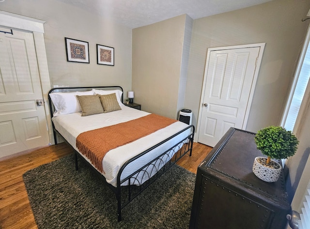 bedroom with hardwood / wood-style floors and a textured ceiling