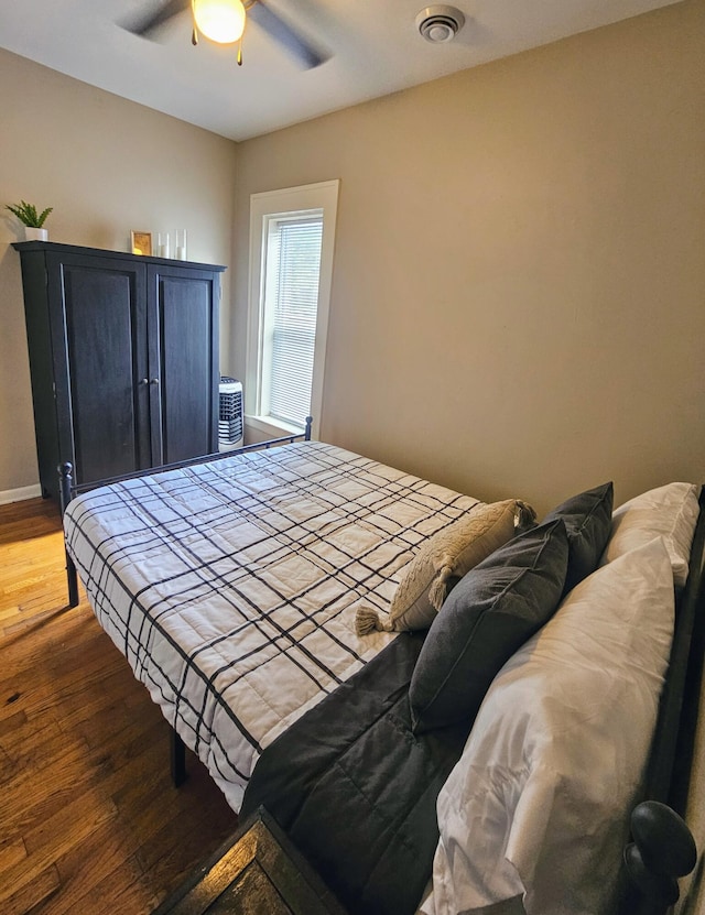 bedroom with ceiling fan and hardwood / wood-style floors