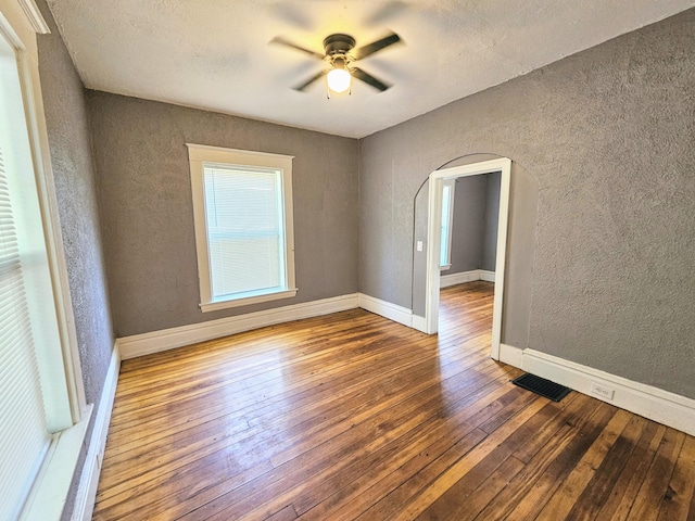 unfurnished bedroom with ceiling fan and hardwood / wood-style flooring