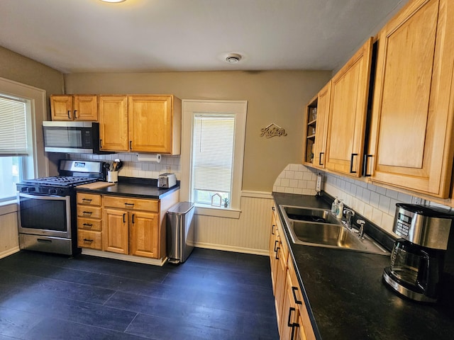 kitchen featuring backsplash, stainless steel appliances, plenty of natural light, and sink