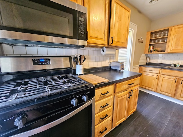 kitchen with decorative backsplash, dark hardwood / wood-style flooring, and stainless steel appliances