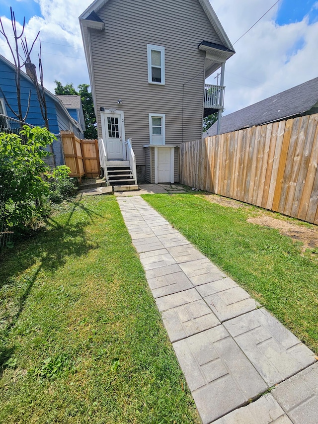 rear view of property with a yard