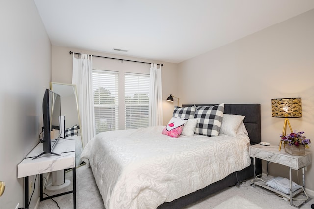 bedroom featuring light colored carpet