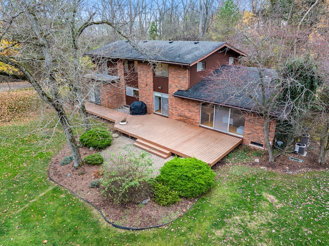 rear view of house featuring a yard and cooling unit