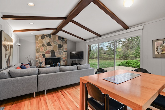 living room featuring wood-type flooring and lofted ceiling with beams