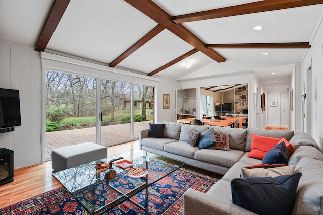 living room with vaulted ceiling with beams and hardwood / wood-style floors