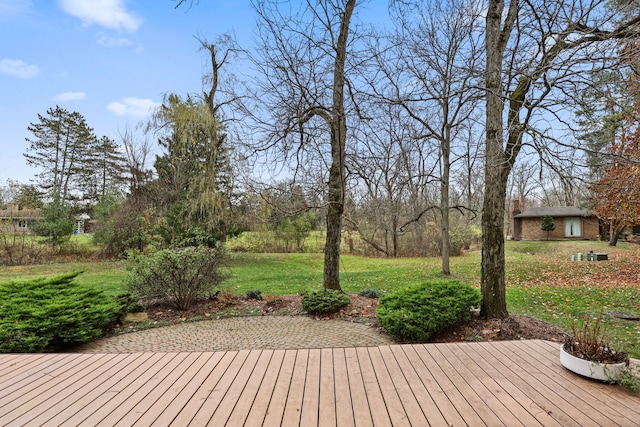 wooden deck with a lawn