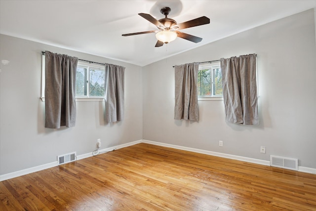 unfurnished room with plenty of natural light, ceiling fan, and light wood-type flooring