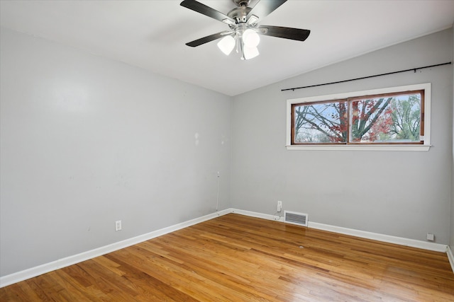 spare room featuring ceiling fan, wood-type flooring, and vaulted ceiling