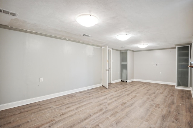 basement with light hardwood / wood-style floors