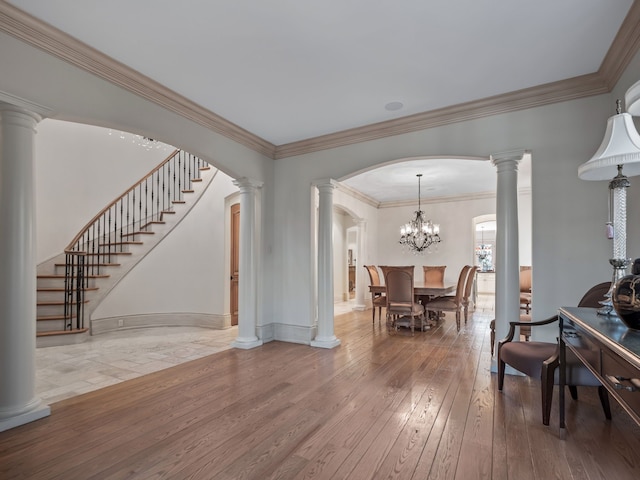 interior space featuring hardwood / wood-style flooring, an inviting chandelier, and crown molding