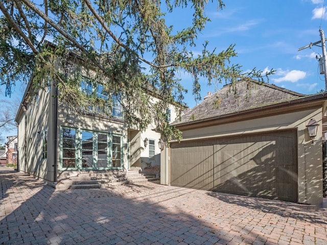 rear view of property with a garage