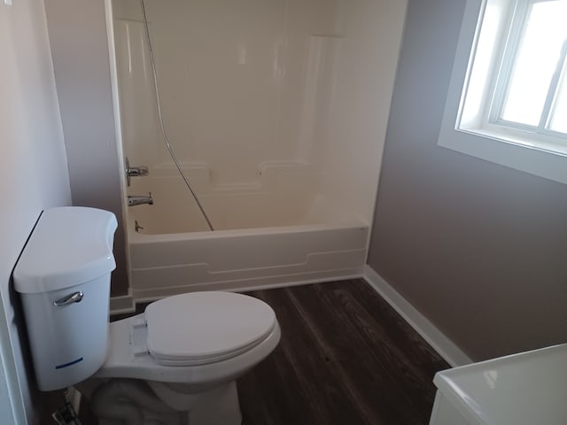 bathroom with shower / bath combination, hardwood / wood-style floors, and toilet