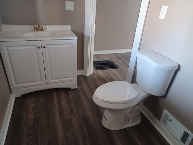 bathroom featuring vanity, wood-type flooring, and toilet