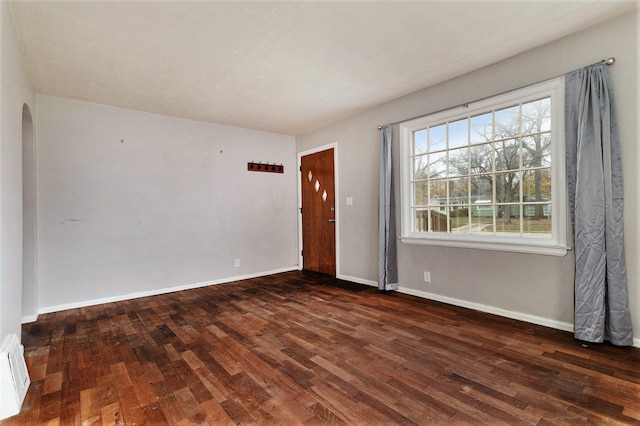 spare room with dark hardwood / wood-style flooring