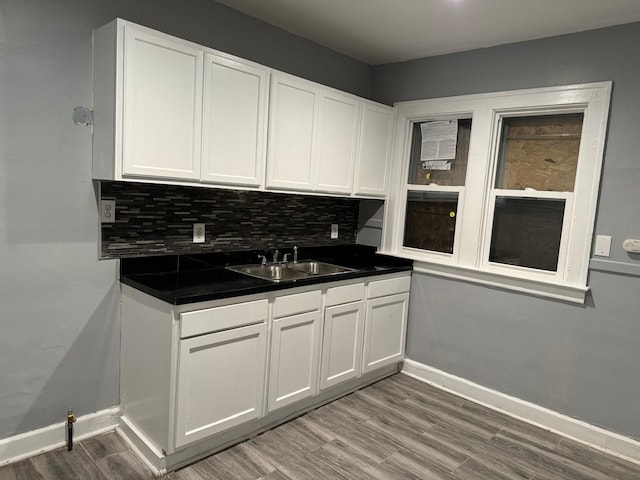 kitchen featuring white cabinets, hardwood / wood-style floors, and sink