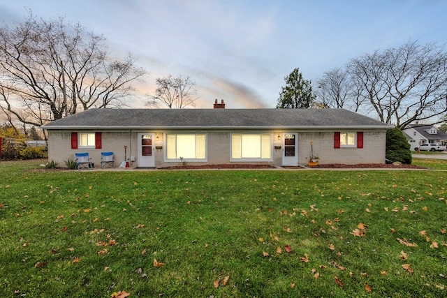 ranch-style house featuring a yard