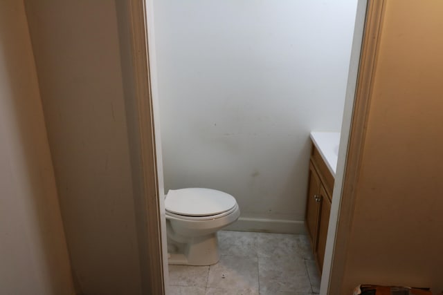 bathroom featuring tile patterned floors, vanity, and toilet