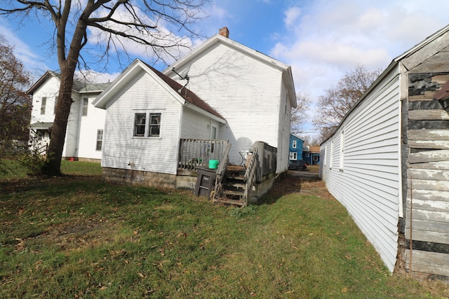 rear view of house featuring a lawn