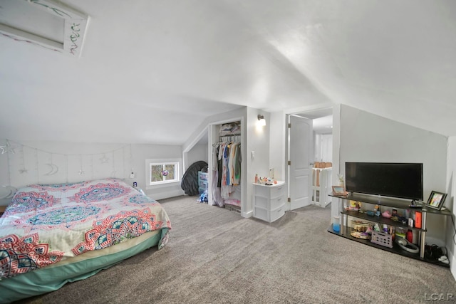 carpeted bedroom with lofted ceiling and a closet