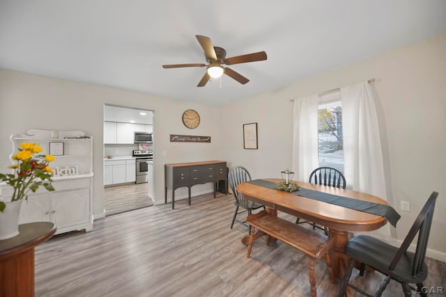 dining room featuring ceiling fan and light wood-type flooring