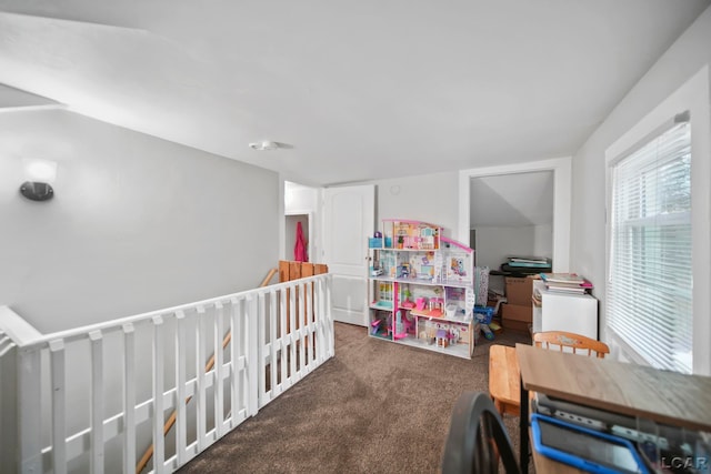 bedroom with dark colored carpet and vaulted ceiling