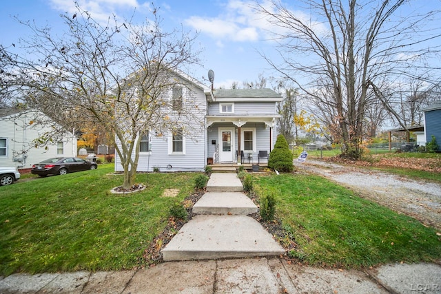 view of front of house featuring a front lawn and covered porch