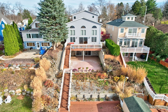 back of house featuring a balcony and a patio area