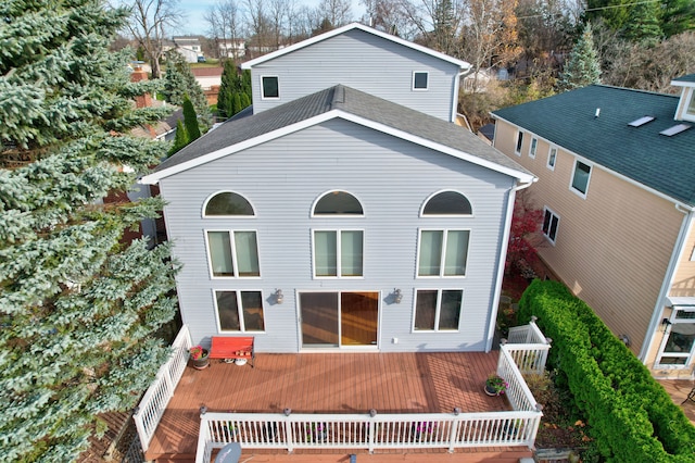 rear view of property featuring a deck