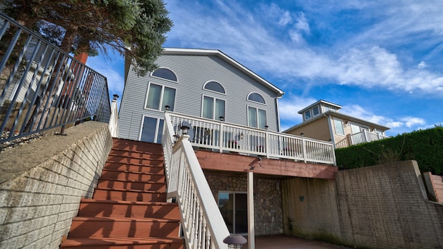 rear view of property featuring a deck