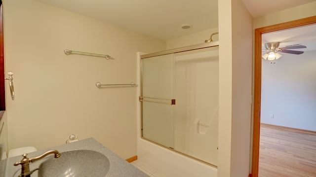 bathroom with ceiling fan, sink, combined bath / shower with glass door, and hardwood / wood-style flooring