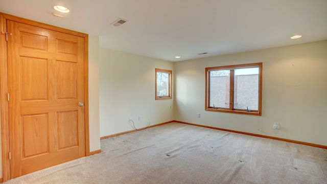 unfurnished room featuring light colored carpet