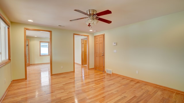 empty room with ceiling fan and light wood-type flooring