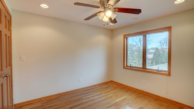 spare room with light wood-type flooring and ceiling fan